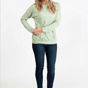 Distressed light green sweatshirt